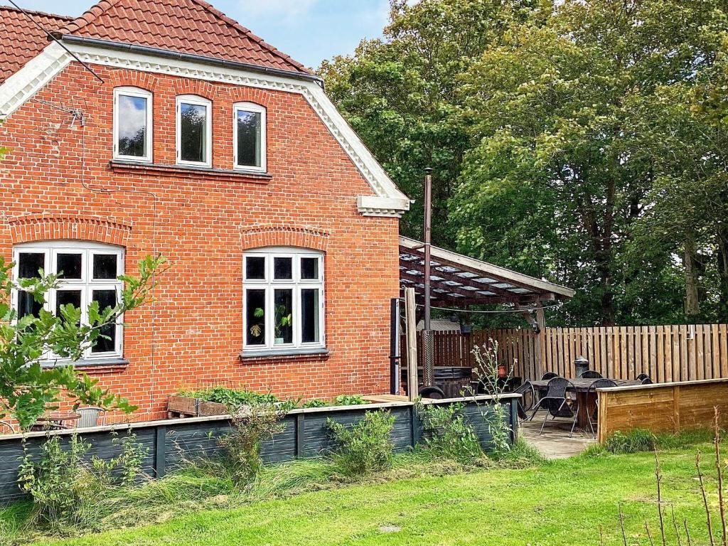 a red brick house with a garden in front of it at 5 star holiday home in Grindsted-By Traum in Grindsted