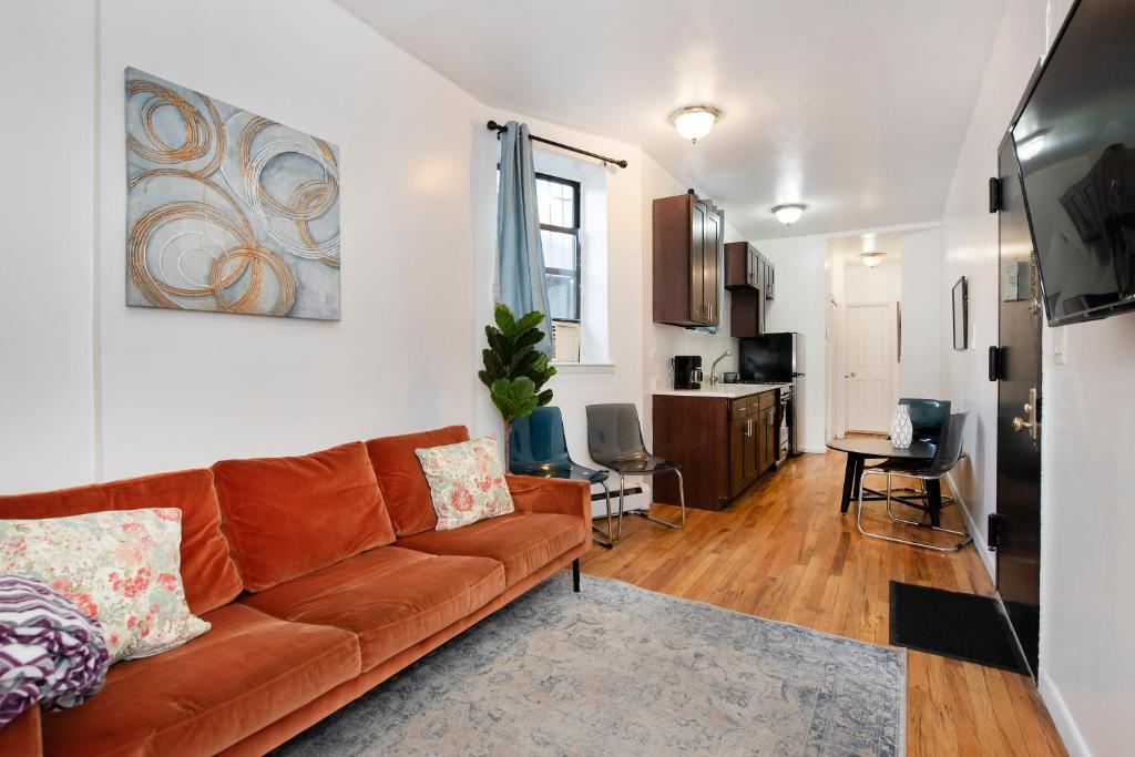 a living room with a couch and a kitchen at 1BR in Upper West Side in New York