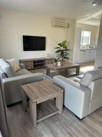 a living room with two couches and a flat screen tv at Harbour View 49 Urch Street Unit 8 in Geraldton