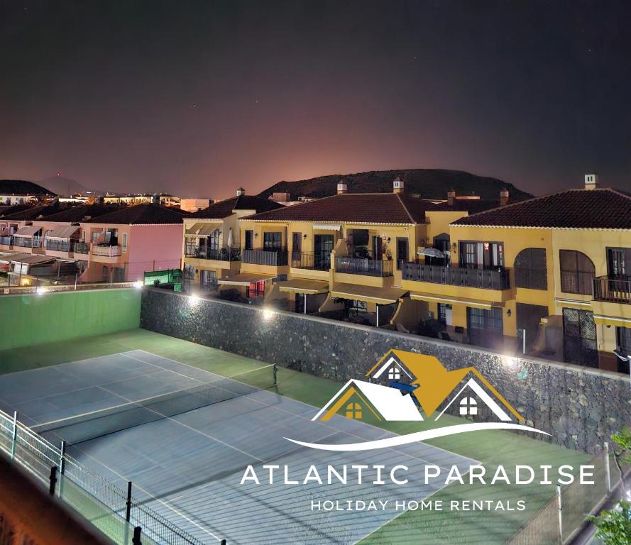 a tennis court in front of some buildings at Atlantic Paradise in Costa Del Silencio
