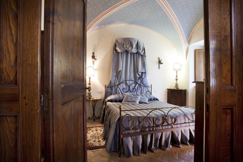 a bedroom with a bed with a canopy at Residenza D'epoca San Crispino in Assisi