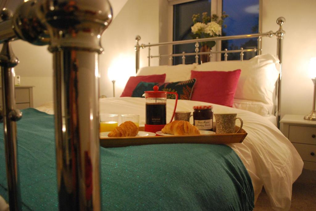 a tray of food on top of a bed at Stylish Hampshire Cottage, Parking, Patio, Dog Friendly, Local Restaurants in Fleet