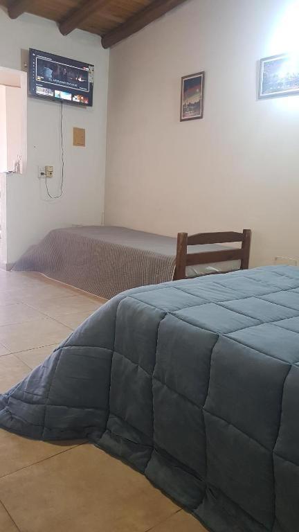 a bedroom with a bed and a television in a room at Monoambiente Blanca in Concordia