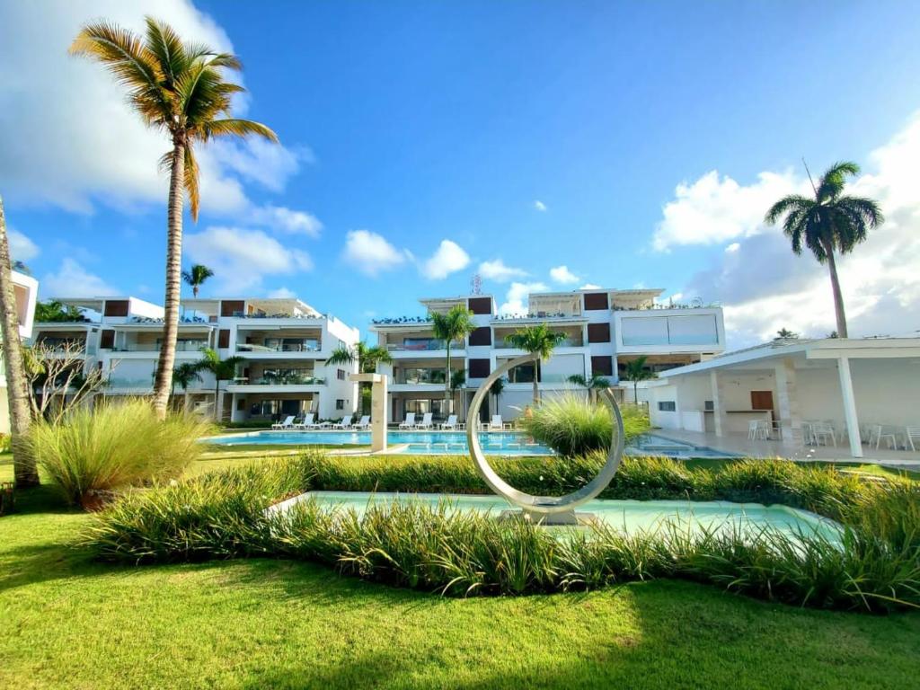 a view of a resort with a pool and a sculpture at Nicole Residence in Las Terrenas