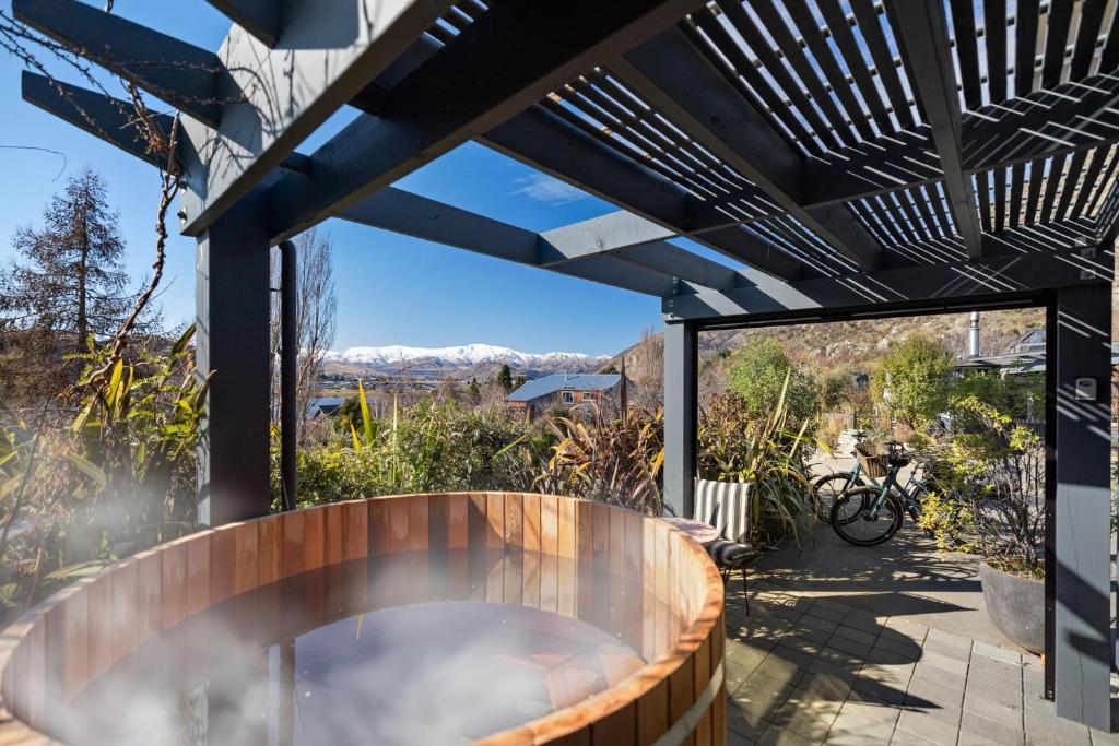 a hot tub on the patio of a house at Queenstown Hot Tub Apartment in Frankton Wharf