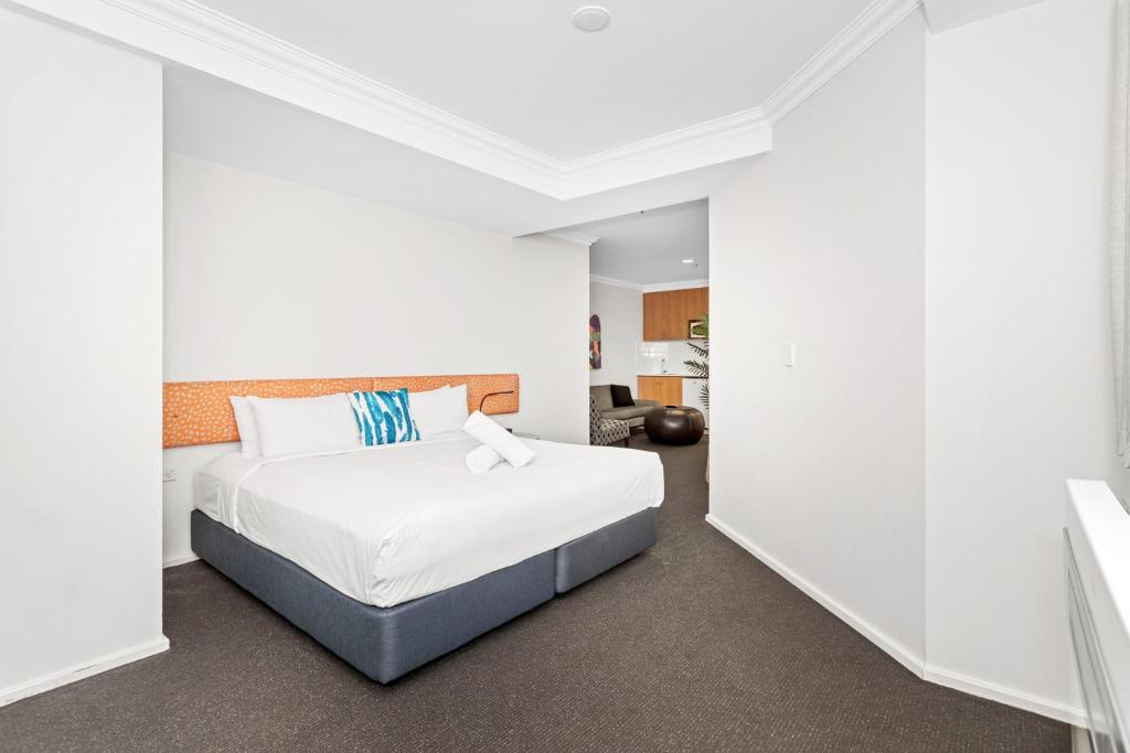a bedroom with a bed in a white room at Downtown Perth Studio On Murray Street in Perth