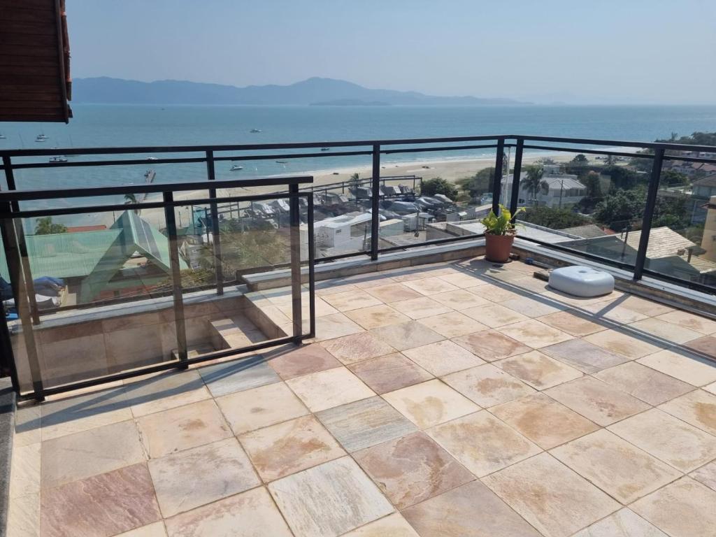 a balcony with a view of the ocean at Jurerê Ocean Flats in Florianópolis