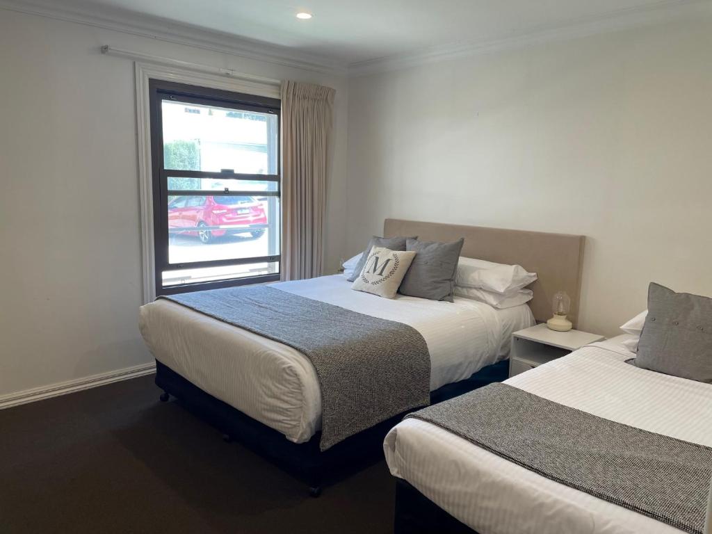 Postel nebo postele na pokoji v ubytování Millthorpe Motel