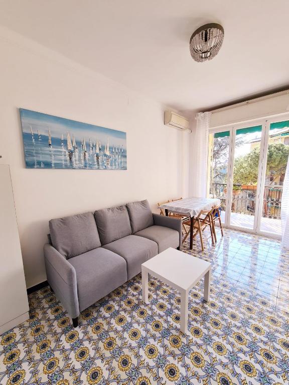 a living room with a couch and a table at Sail Away Camogli in Camogli