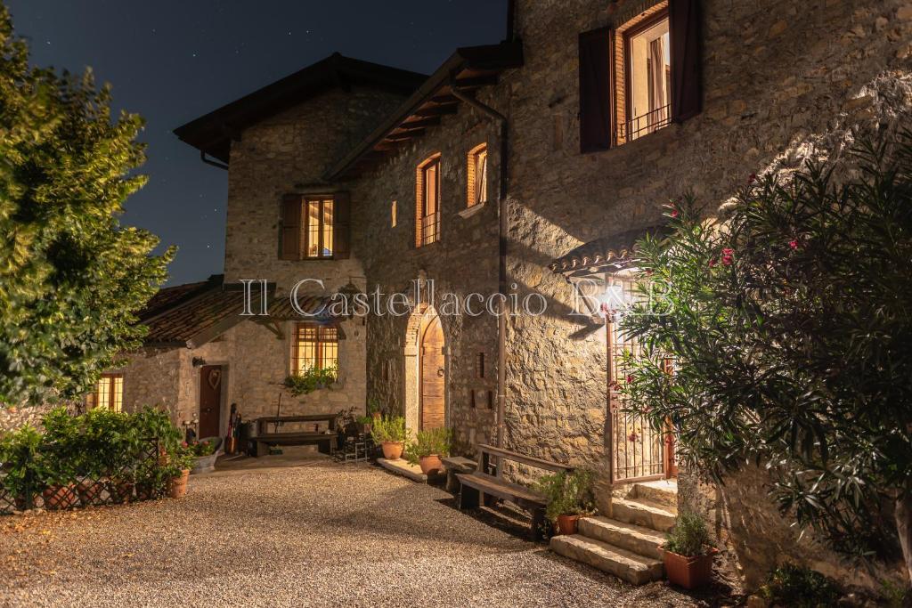 a stone house with a pathway in front of it at B&B Il Castellaccio - Albavilla in Albavilla