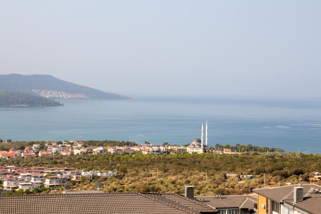 a view of a city and a body of water at Sea View Flat with Shared Pool 5 min to Beach in Akbük