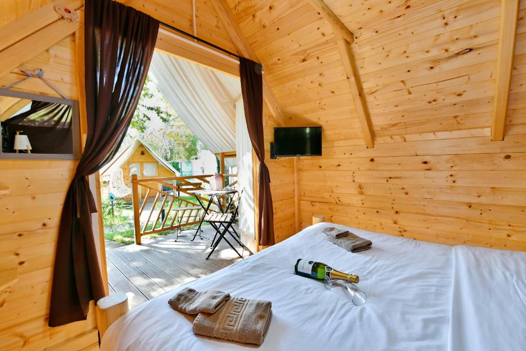 a bedroom with a bed in a wooden cabin at Polidor Glamping Resort in Poreč