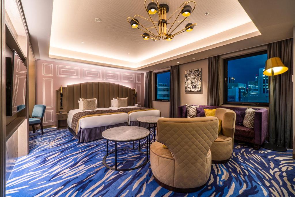 大阪市にあるザ ロイヤルパーク キャンバス 大阪北浜のベッド2台と椅子が備わるホテルルームです。
