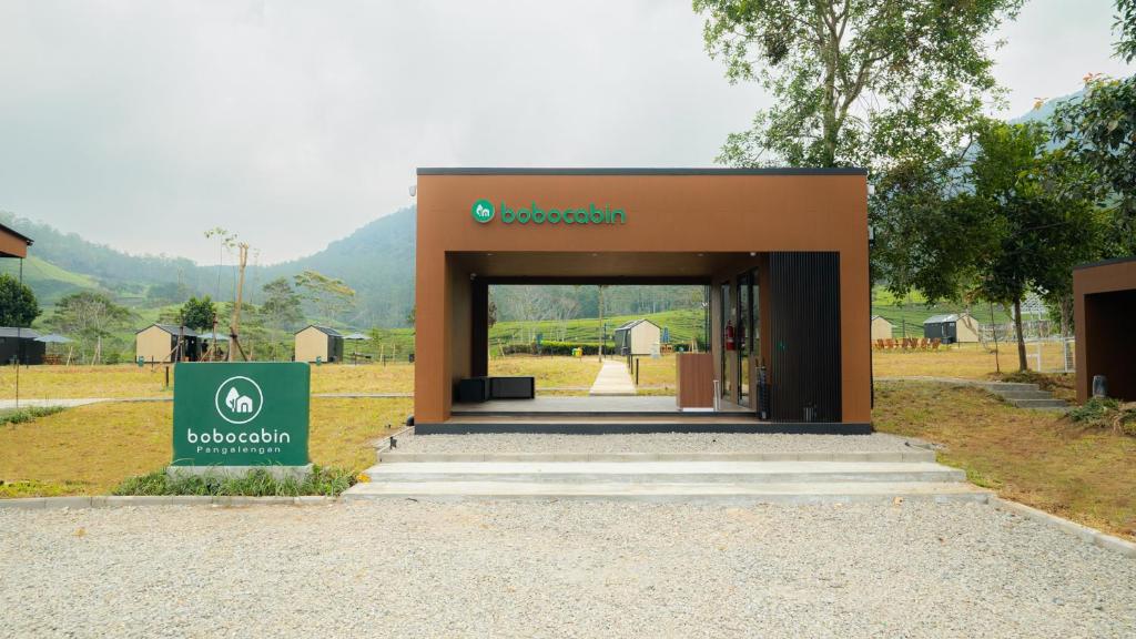 a building with a sign in front of it at Bobocabin Pangalengan, Bandung in Pengalongan