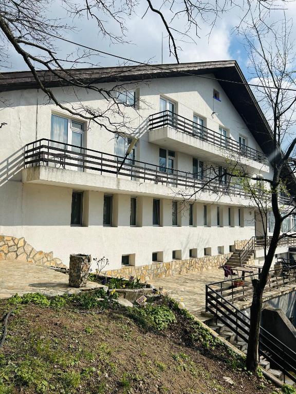 a white building with balconies on the side of it at Комплекс Тополица -The beautiful view in Aytos