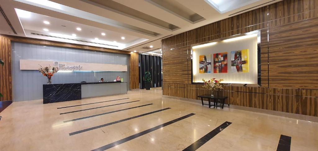 a lobby with a reception desk and a large wall at The Elements service apartment, Jalan Ampang in Kuala Lumpur