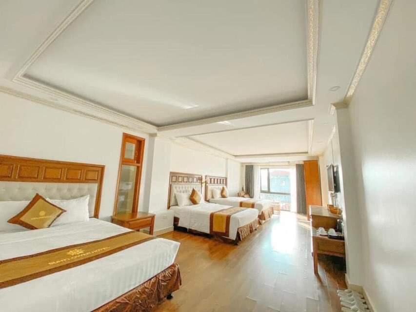 a hotel room with two beds and a large window at Lake Panorama in Sa Pa
