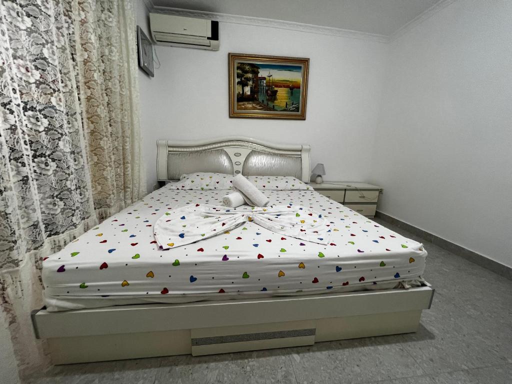 sypialnia z białym łóżkiem i konfetti w obiekcie BOULEVARD Apartment w Tiranie