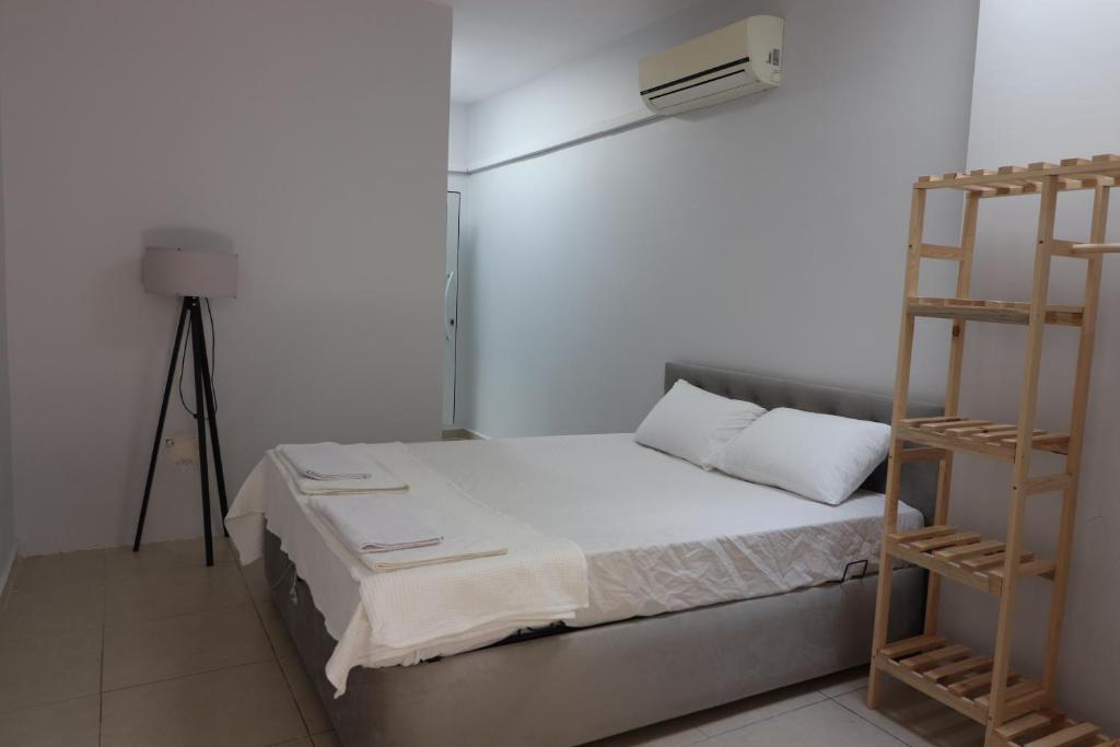 a small bedroom with a bed with a ladder at power suit in Fethiye