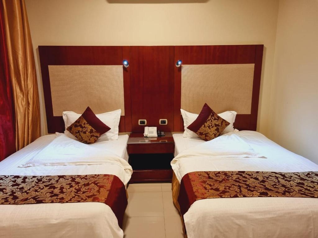 Postel nebo postele na pokoji v ubytování رؤوم ان للشقق الفندقية-Raoum Inn Hotel Apartments