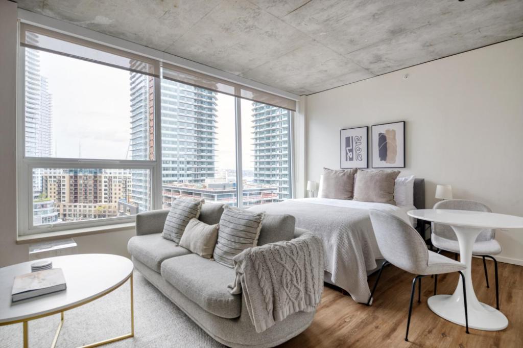 a bedroom with a large bed and a couch at South Lake Union studio w gym storage nr parks SEA-558 in Seattle