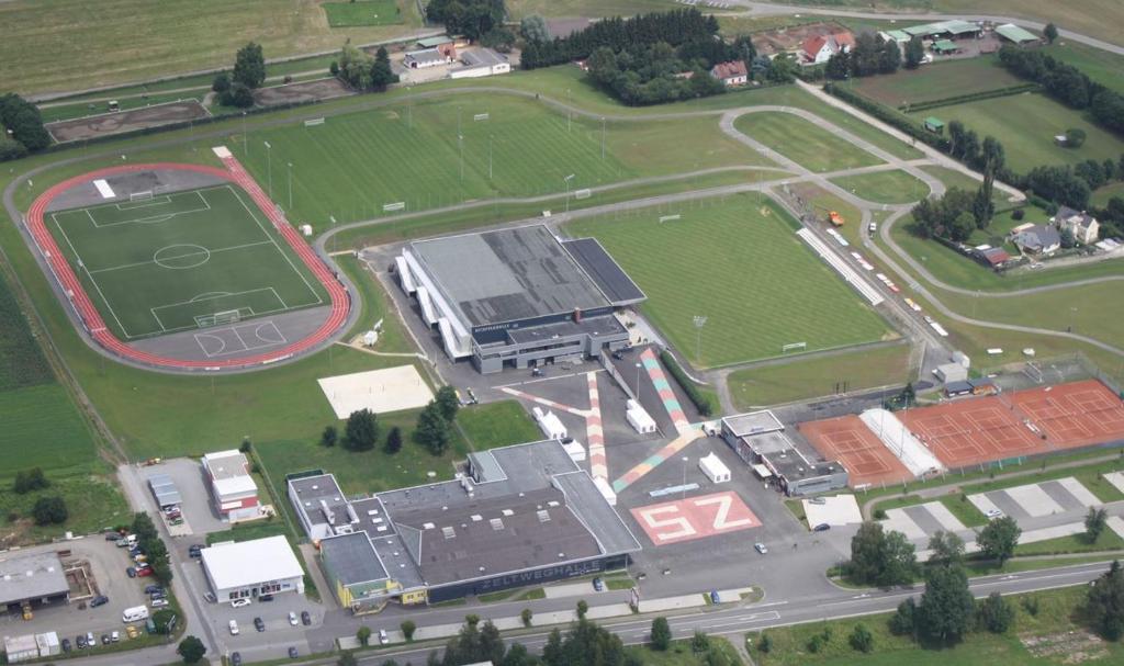 an aerial view of a soccer field and a building at Camping Sportzentrum Zeltweg - a silent alternative in Zeltweg