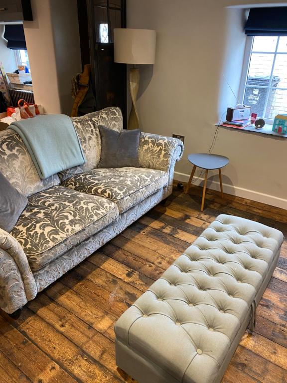 a living room with a couch and a table at Sunnyside cottage in Braunton