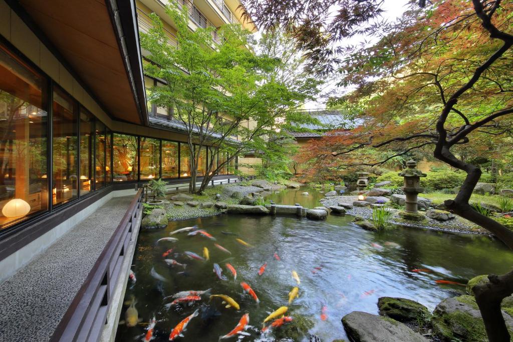 a koi pond in front of a building at Tachibanaya in Tsuruoka