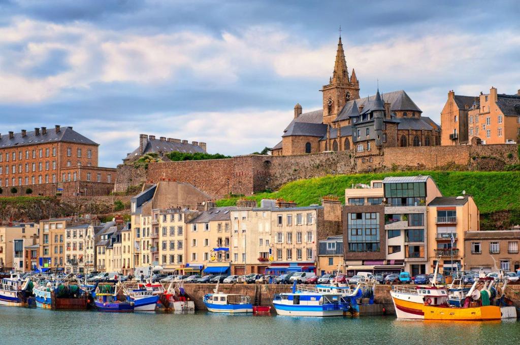 a group of boats docked in the water near a city at Appartement "La Marine" vue mer in Saint-Pair-sur-Mer