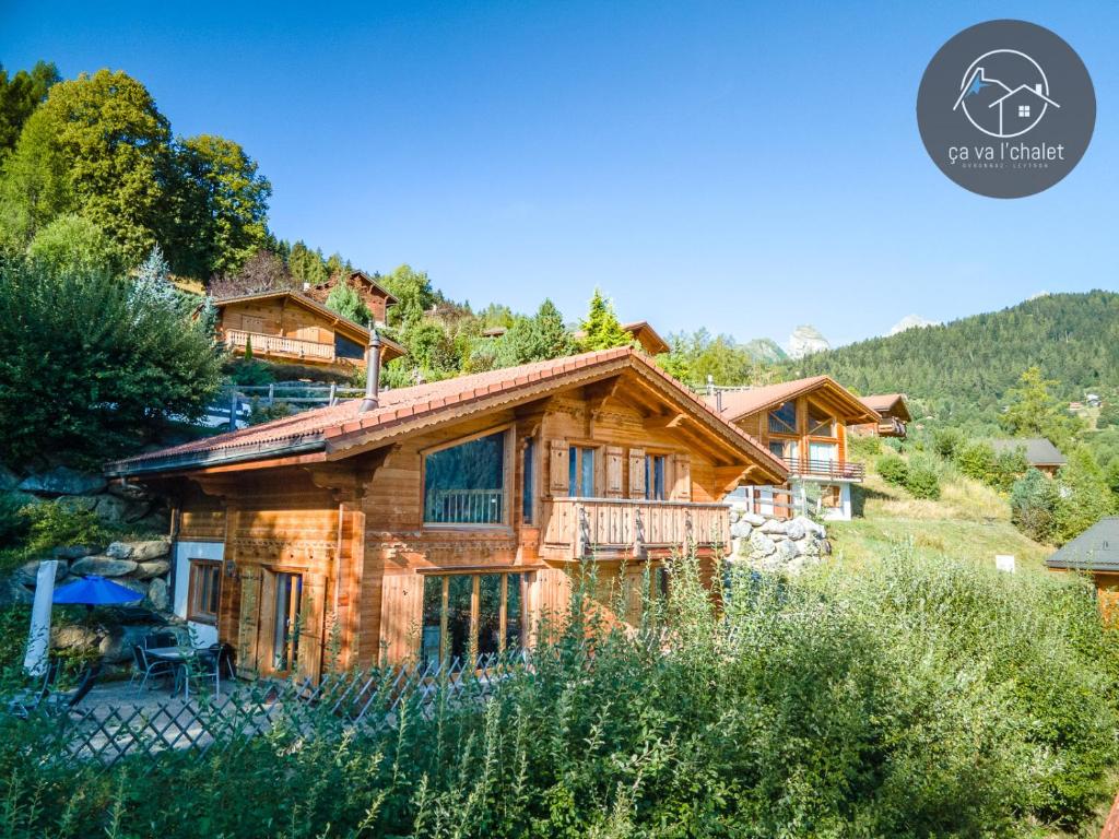 a log cabin in the mountains with a house at Chalet Chez Cheryl, Mayens-de-Chamoson in Ovronnaz