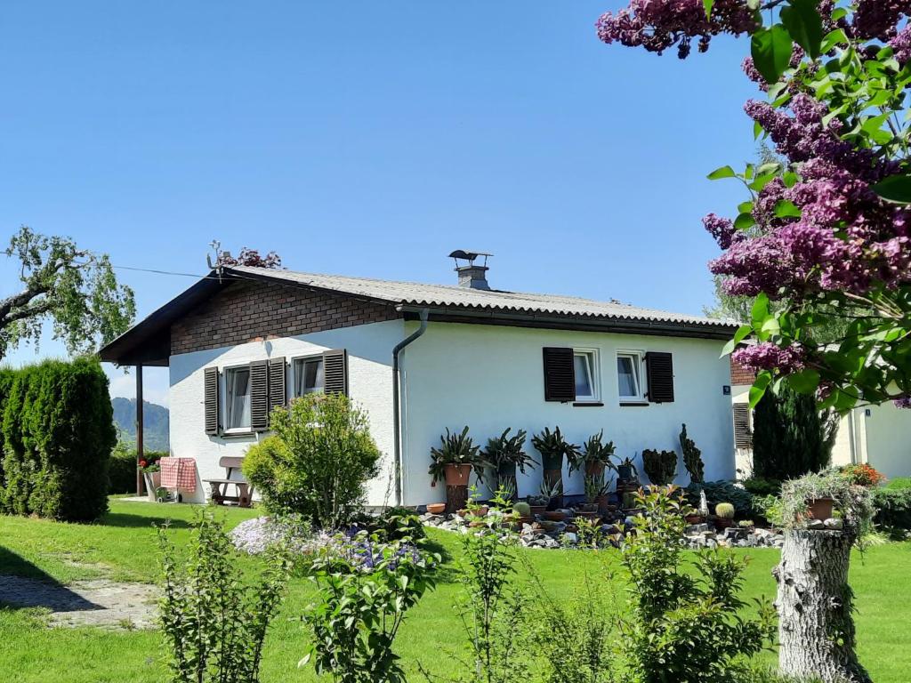 een wit huis met een tuin ervoor bij Bungalows Raschun Grabelsdorf Etruskerweg 10 A-9122 St.Kanzian in Grabelsdorf