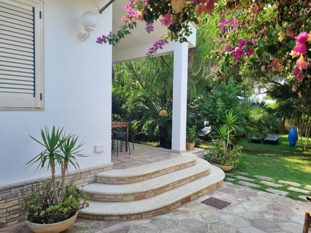 a patio with stairs and flowers at Villa Ada Casa Vacanze in Torre Specchia Ruggeri