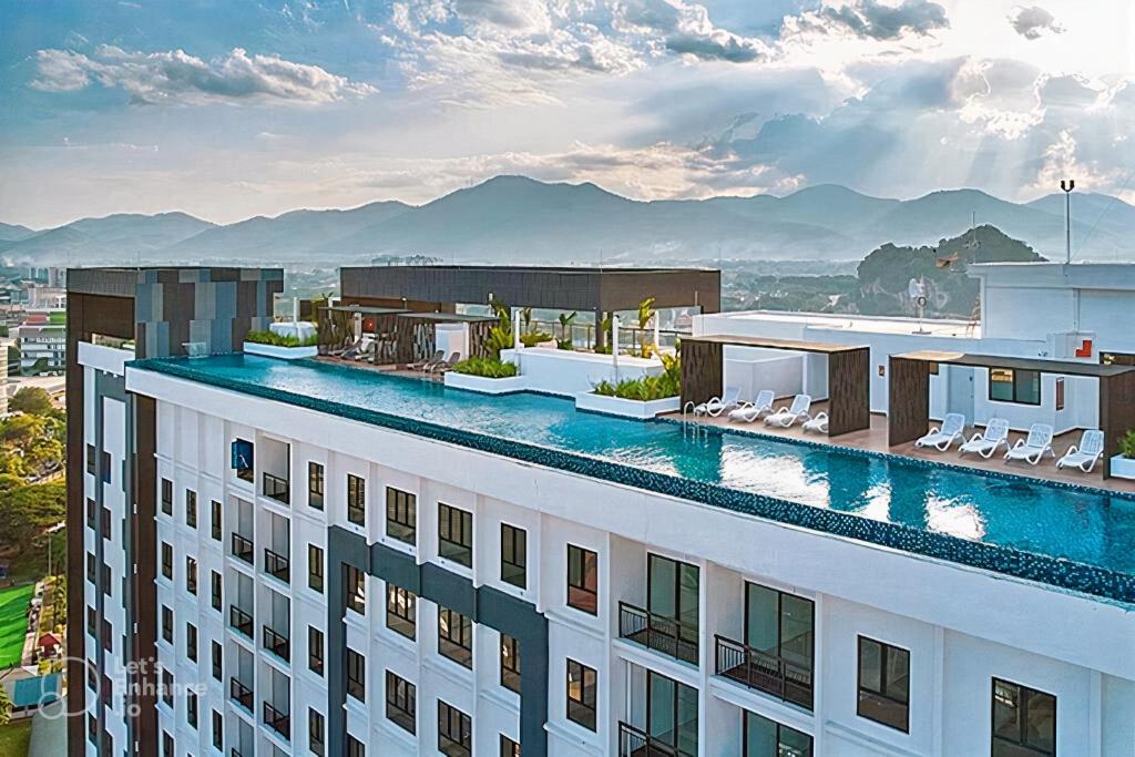 a hotel with a swimming pool on top of a building at The Horizon - Ipoh in Ipoh