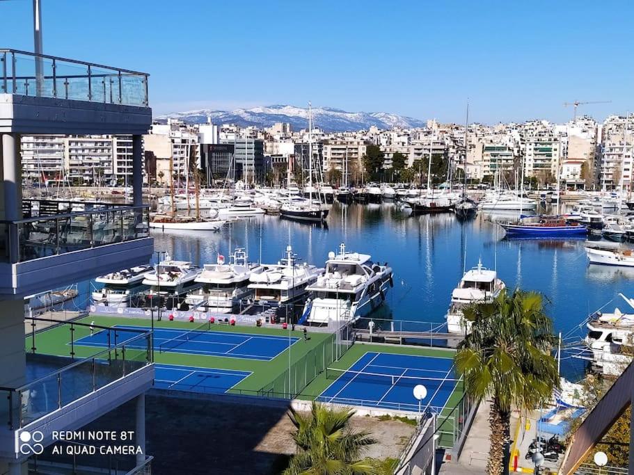 a tennis court in a marina with boats at Athens Sky Suites 1 in Piraeus