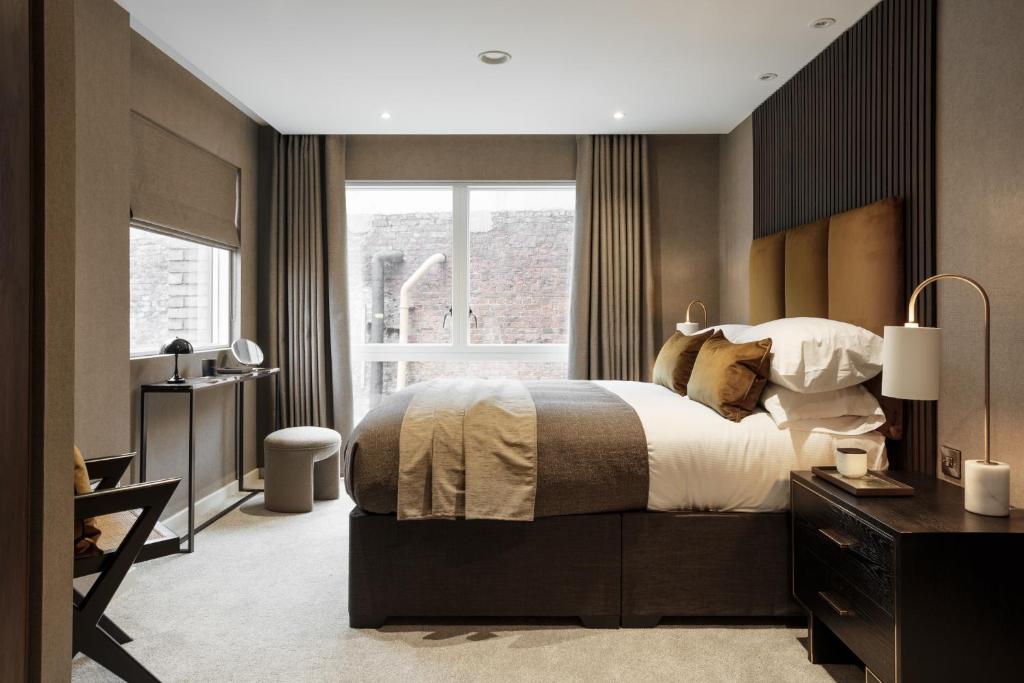 a bedroom with a large bed and a window at 9 Kings, Hudson Quarters- FREE PARKING in York