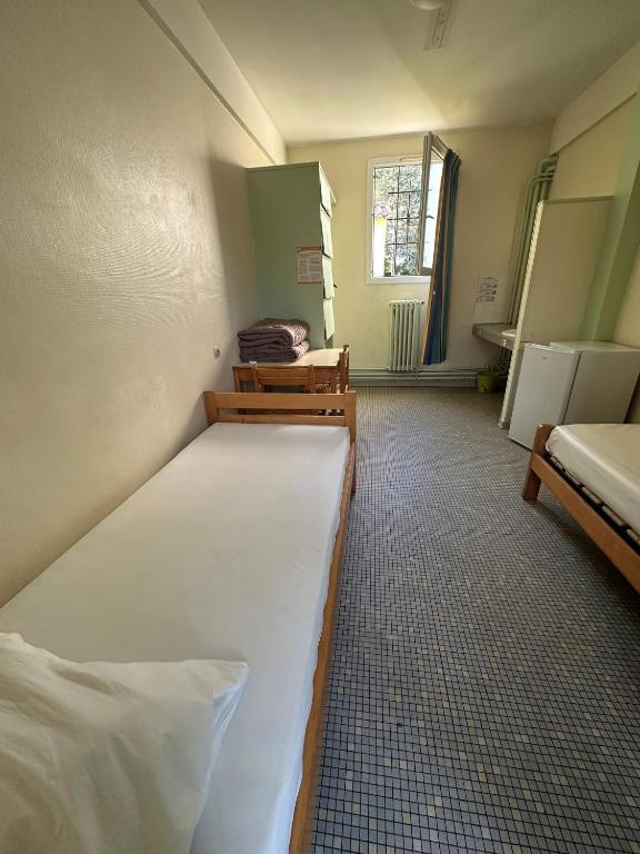 Łóżko lub łóżka w pokoju w obiekcie Auberge de jeunesse HI Poitiers