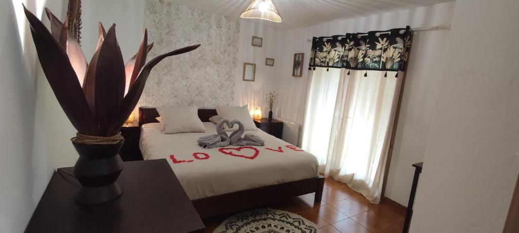 a bedroom with a bed and a vase on a table at Chambre d&#39;hôte Amouratcha in Fabrègues