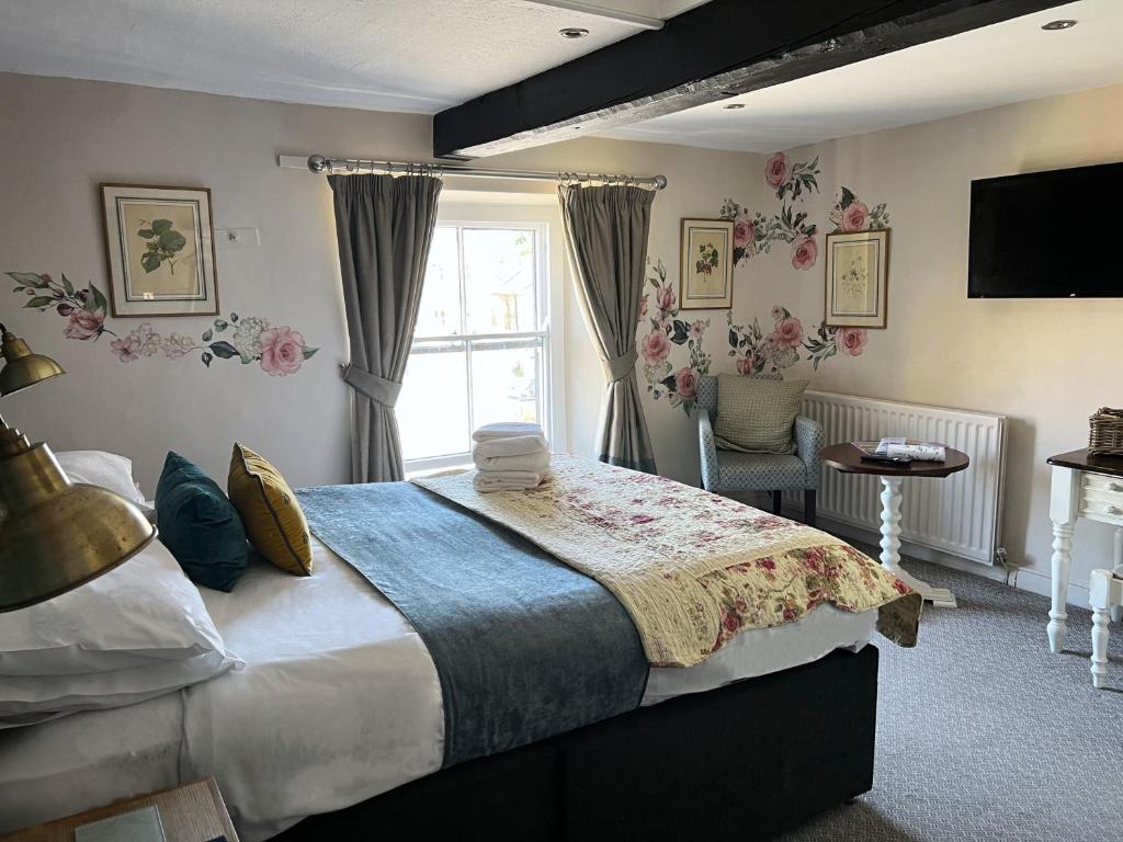 a bedroom with a large bed and a window at The Bay Horse, Masham in Masham