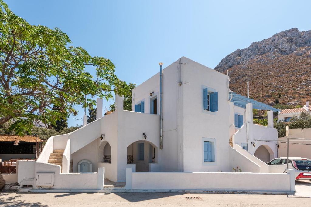 a white house with a mountain in the background at Giannis apartment in Kalymnos