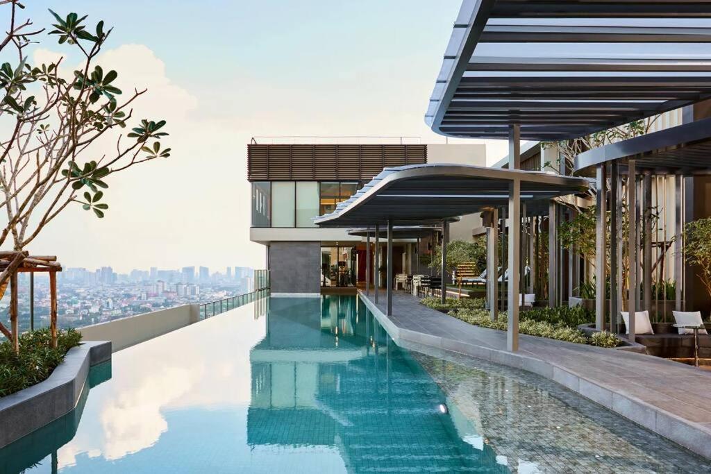 a swimming pool on the roof of a building at N Condominium in Ban Bang Khen (1)