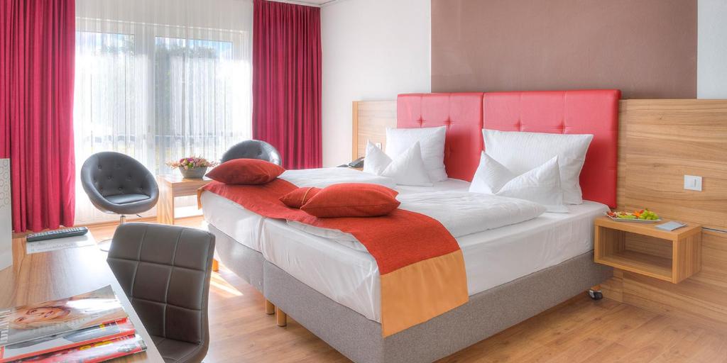Postel nebo postele na pokoji v ubytování ACHAT Hotel Frankfurt Maintal
