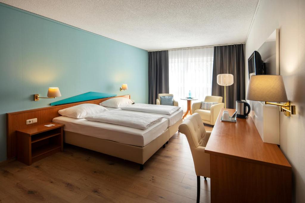 Postel nebo postele na pokoji v ubytování ACHAT Hotel Frankfurt Maintal