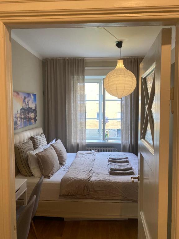 a bedroom with a large bed with a window at Shared apartment close to the city center in Stockholm