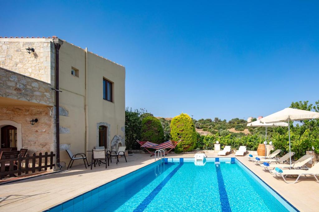 a villa with a swimming pool and a patio at Villa Satra in Elefterna