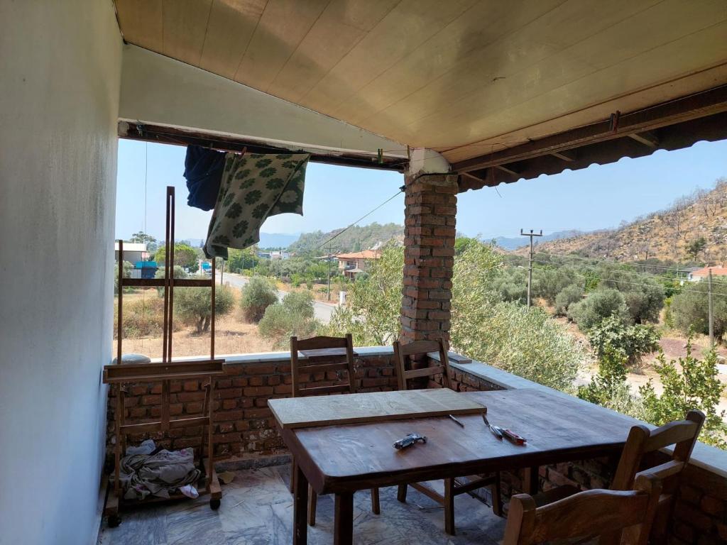a table and chairs on a porch with a view at Zima Art Studio in Marmaris