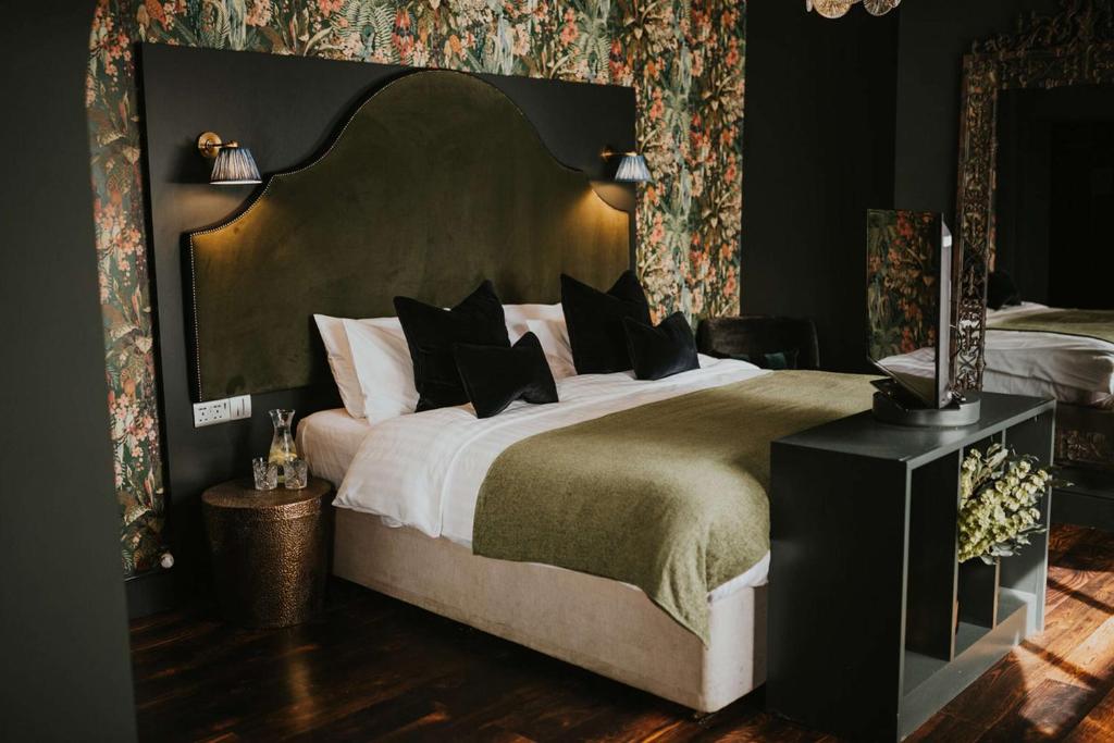 a bedroom with a large bed with a large headboard at The Croft Hotel, BW Signature Collection in Darlington