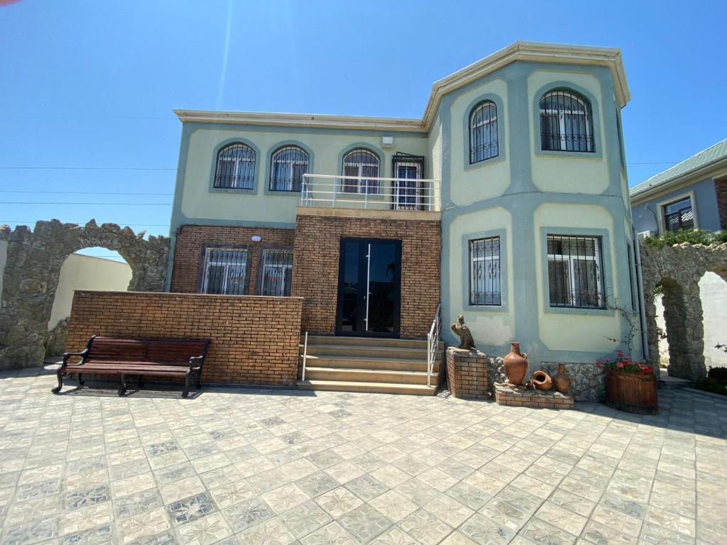 a large house with a bench in front of it at Baku, Shagan Villa in Baku