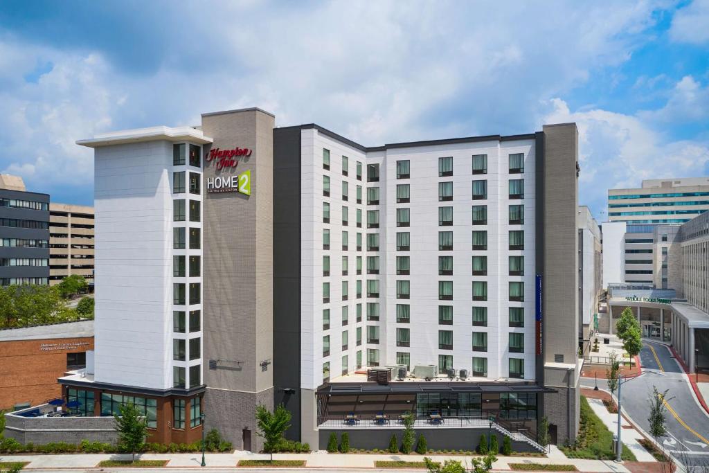 a large white hotel building in a city at Hampton Inn Towson Downtown in Towson