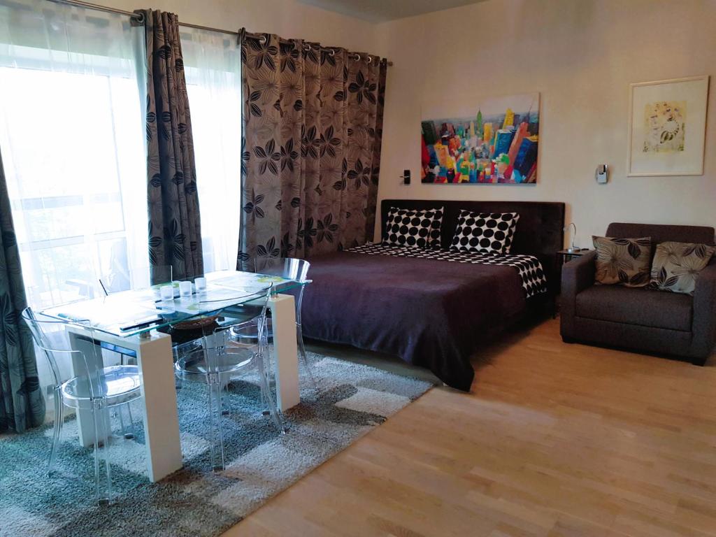 a living room with a couch and a glass table at Sunny Beach Apartment in Narva-Jõesuu