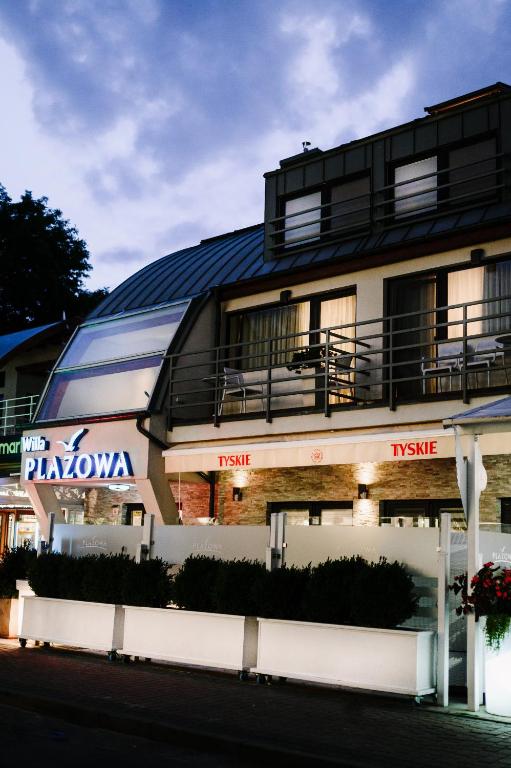a building with a sign on the side of it at Willa Plażowa in Międzyzdroje